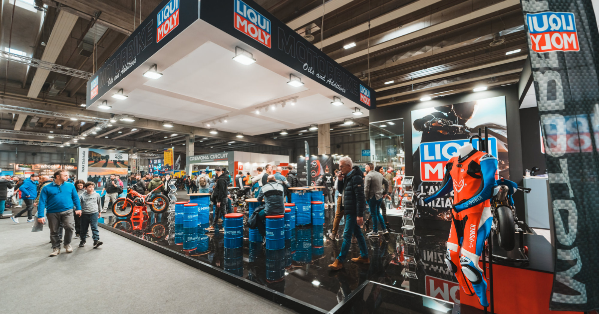 Motorcycle expo booth with attendees